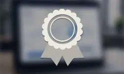 Rosette medal badge with scalloped edge and two ribbon tails on a blurred background